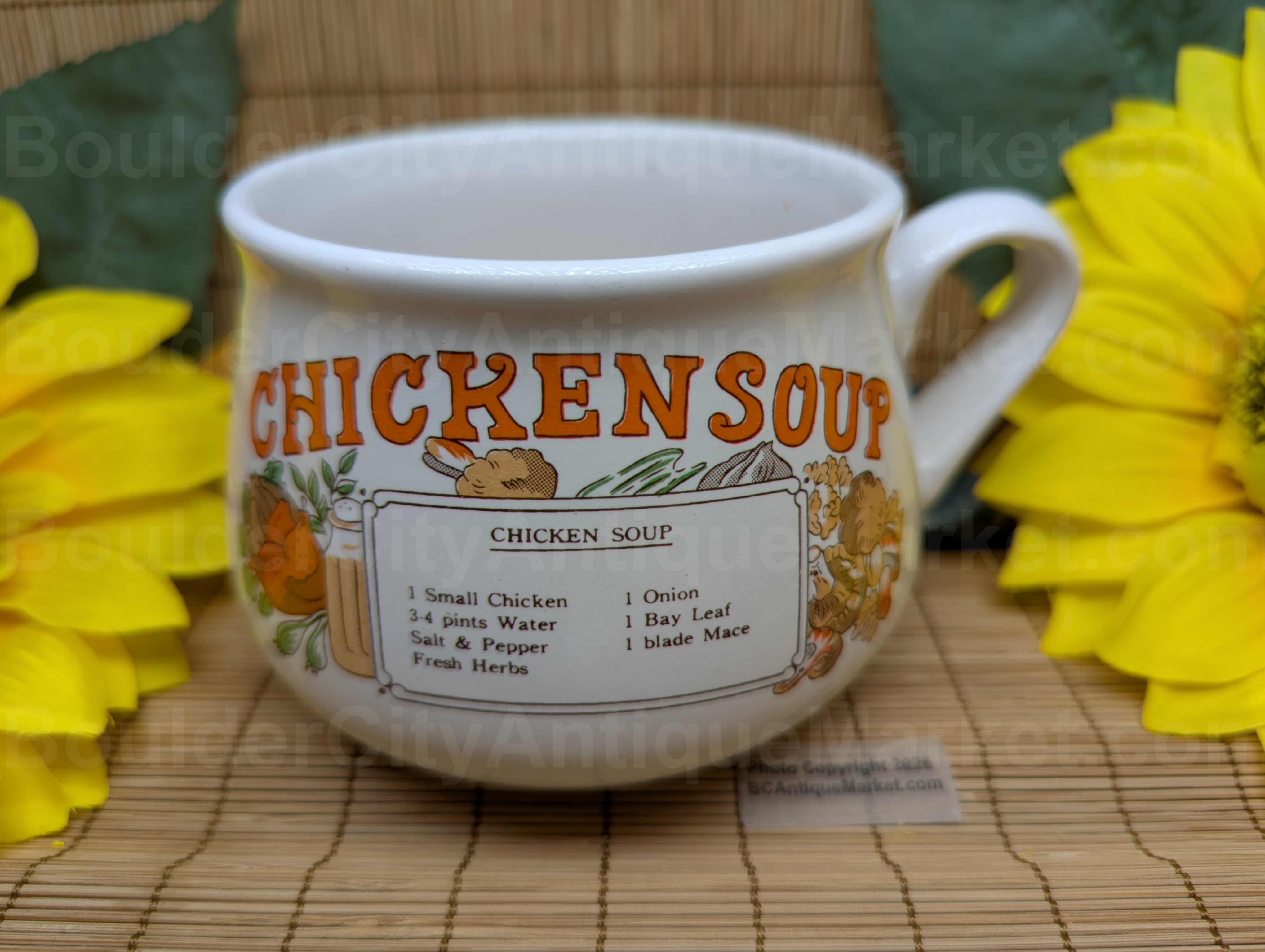 Chicken soup recipe mug. Letters are orange, vegetables surrounding the recipe are in shades of orange, tans, browns and yellow browns.