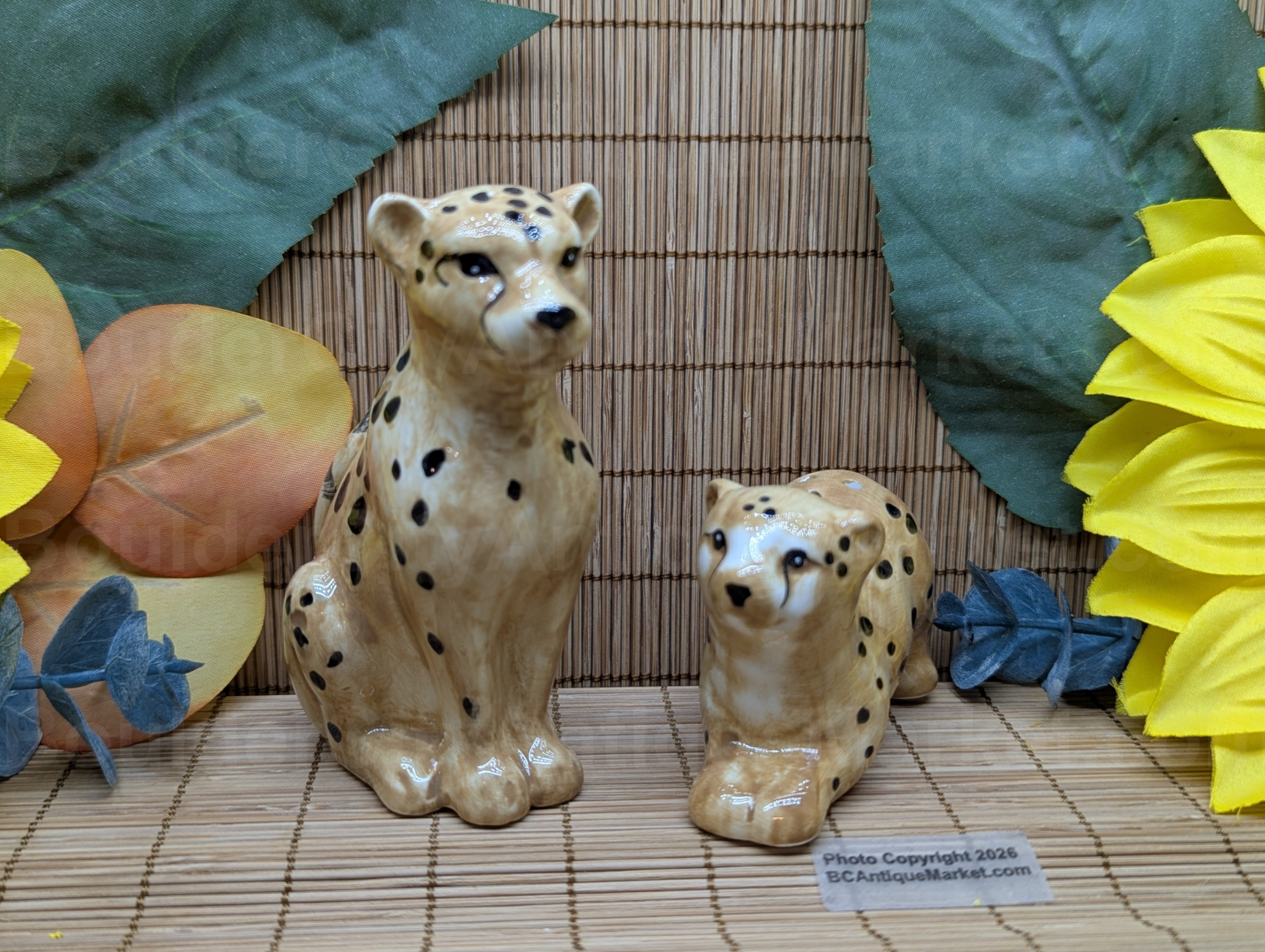 New set of salt and pepper shakers in the shape of a cheetah and her cub. Adult stands four inches tall and cub is three inches long.