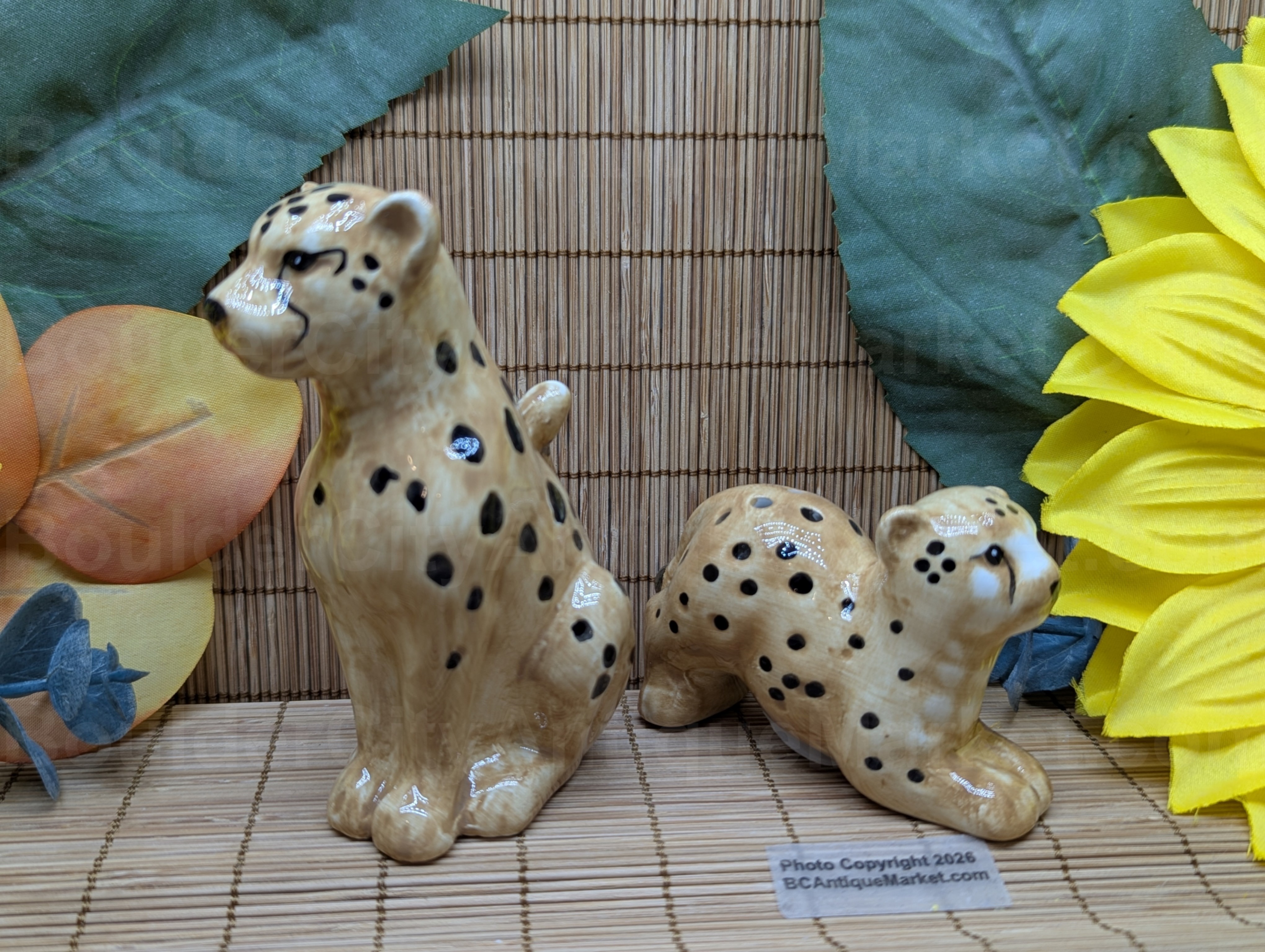 New set of salt and pepper shakers in the shape of a cheetah and her cub. Adult stands four inches tall and cub is three inches long.