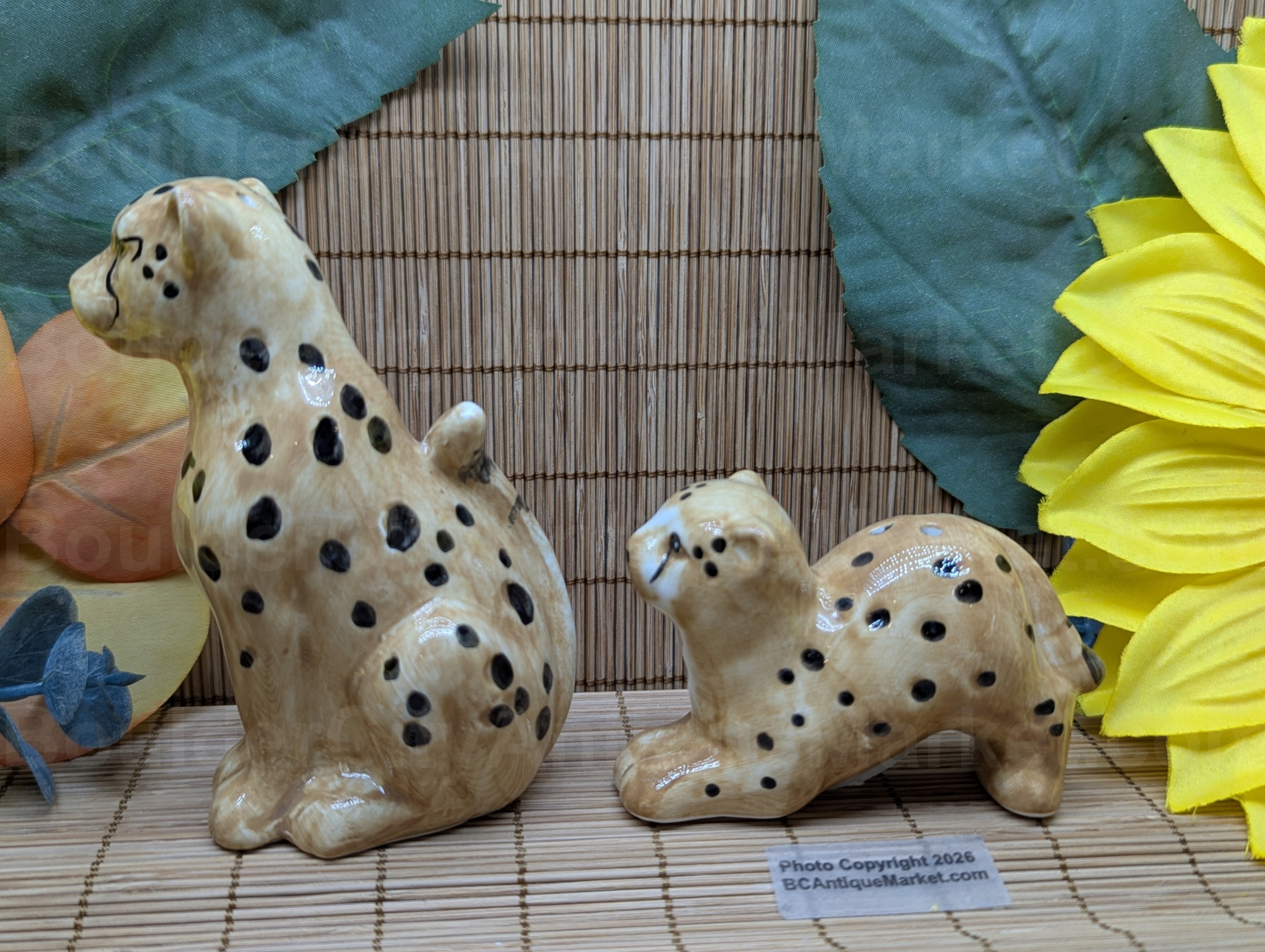 New set of salt and pepper shakers in the shape of a cheetah and her cub. Adult stands four inches tall and cub is three inches long.