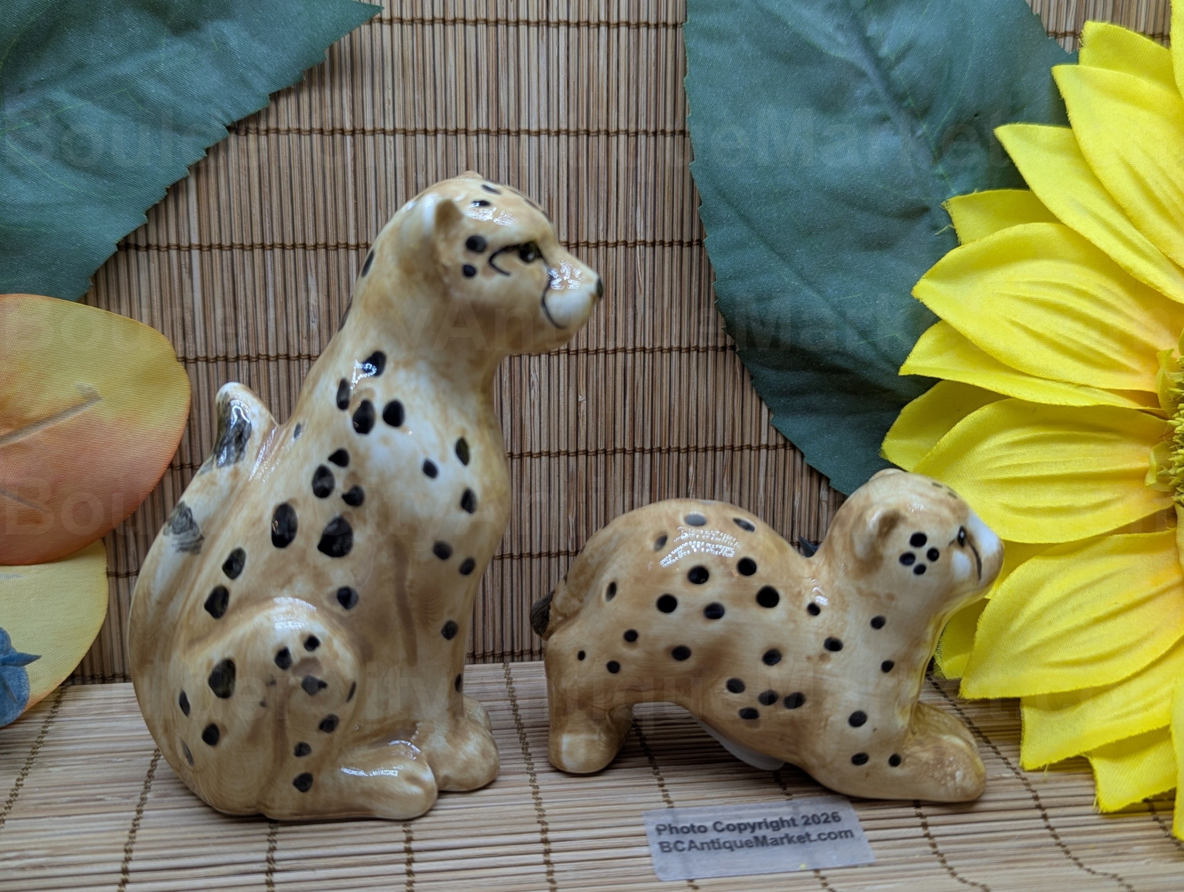 New set of salt and pepper shakers in the shape of a cheetah and her cub. Adult stands four inches tall and cub is three inches long.