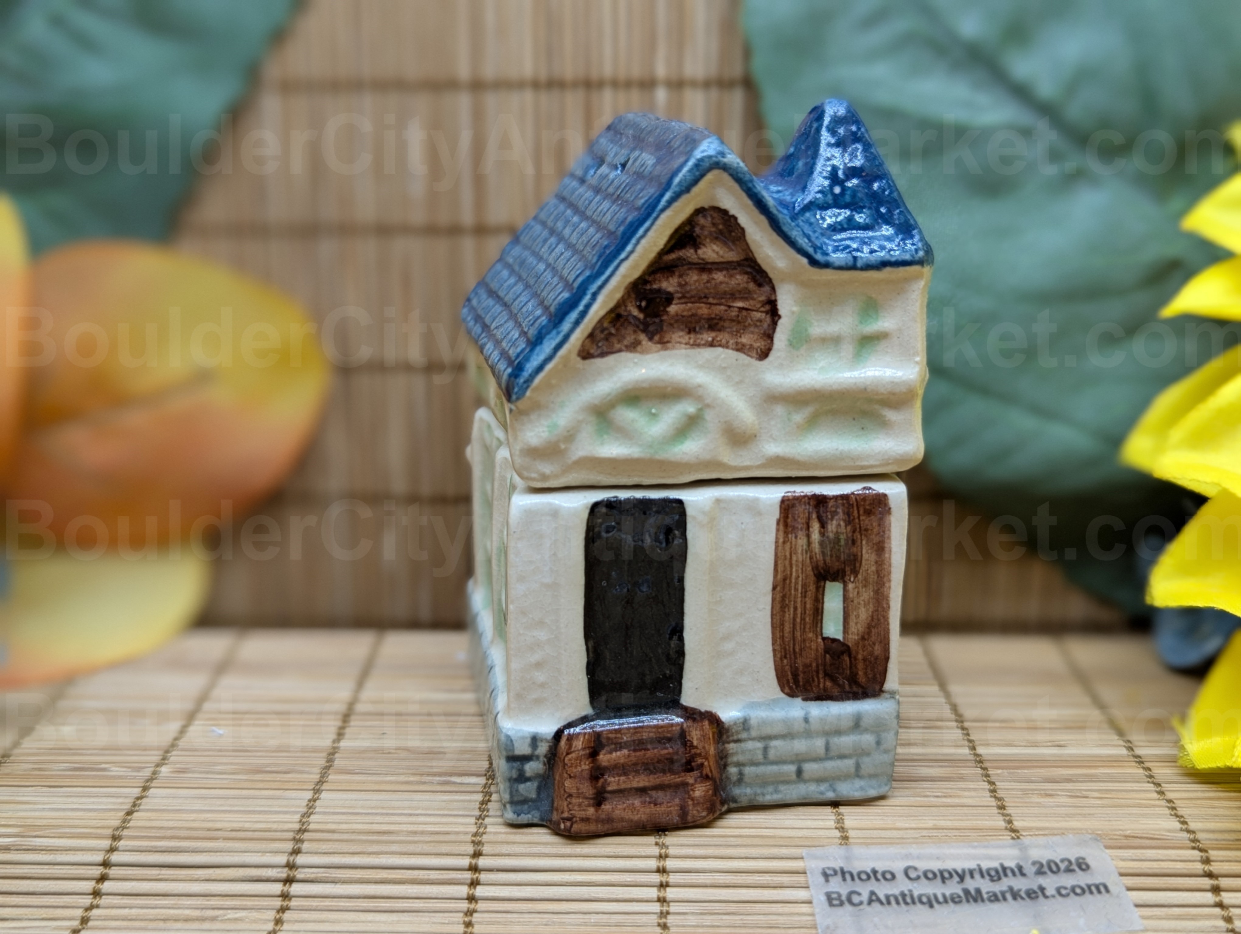 Blue roofed greenish and beige house salt and pepper set stands three inches tall when stacked. 
