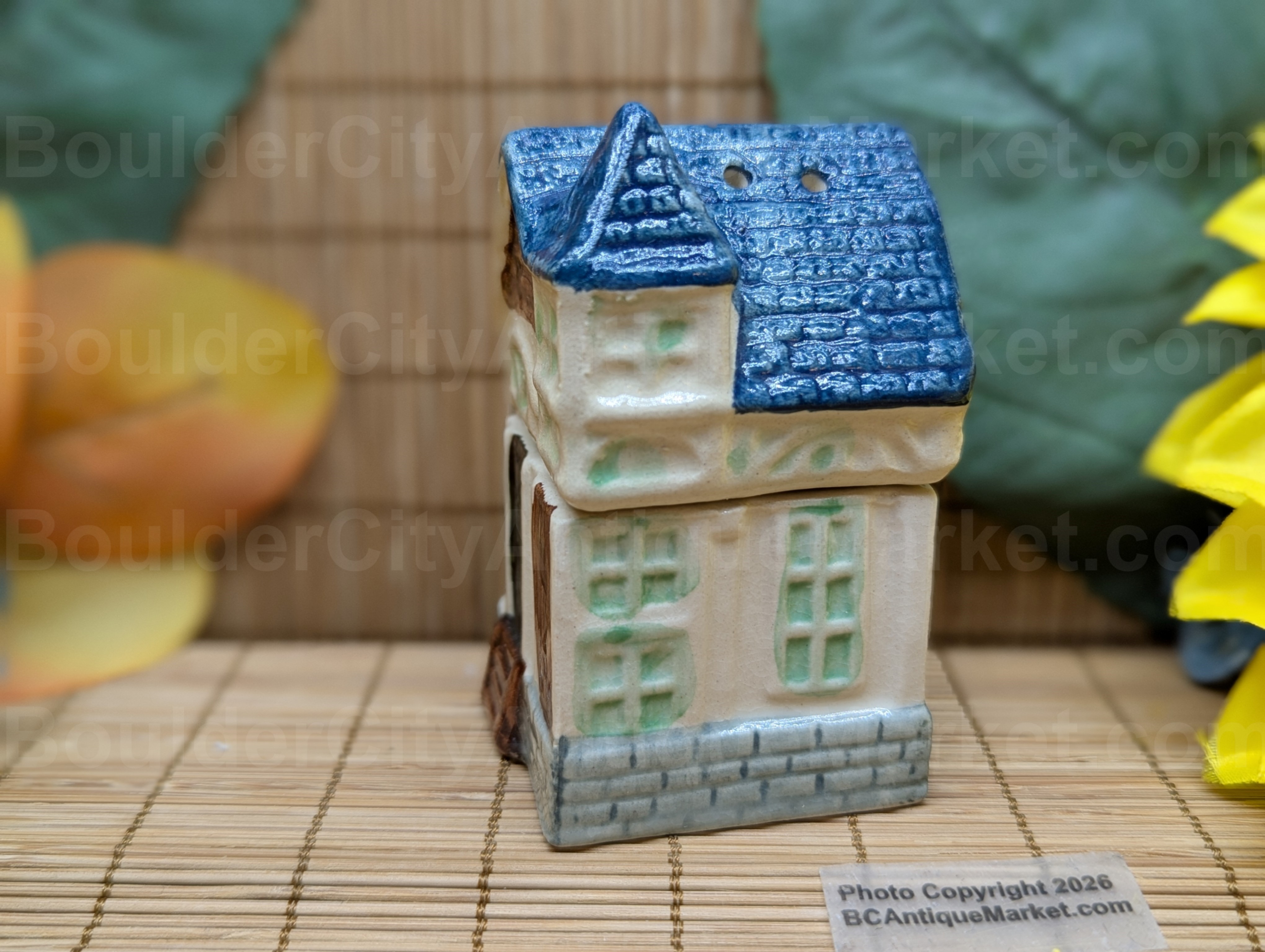 Blue roofed greenish and beige house salt and pepper set stands three inches tall when stacked.