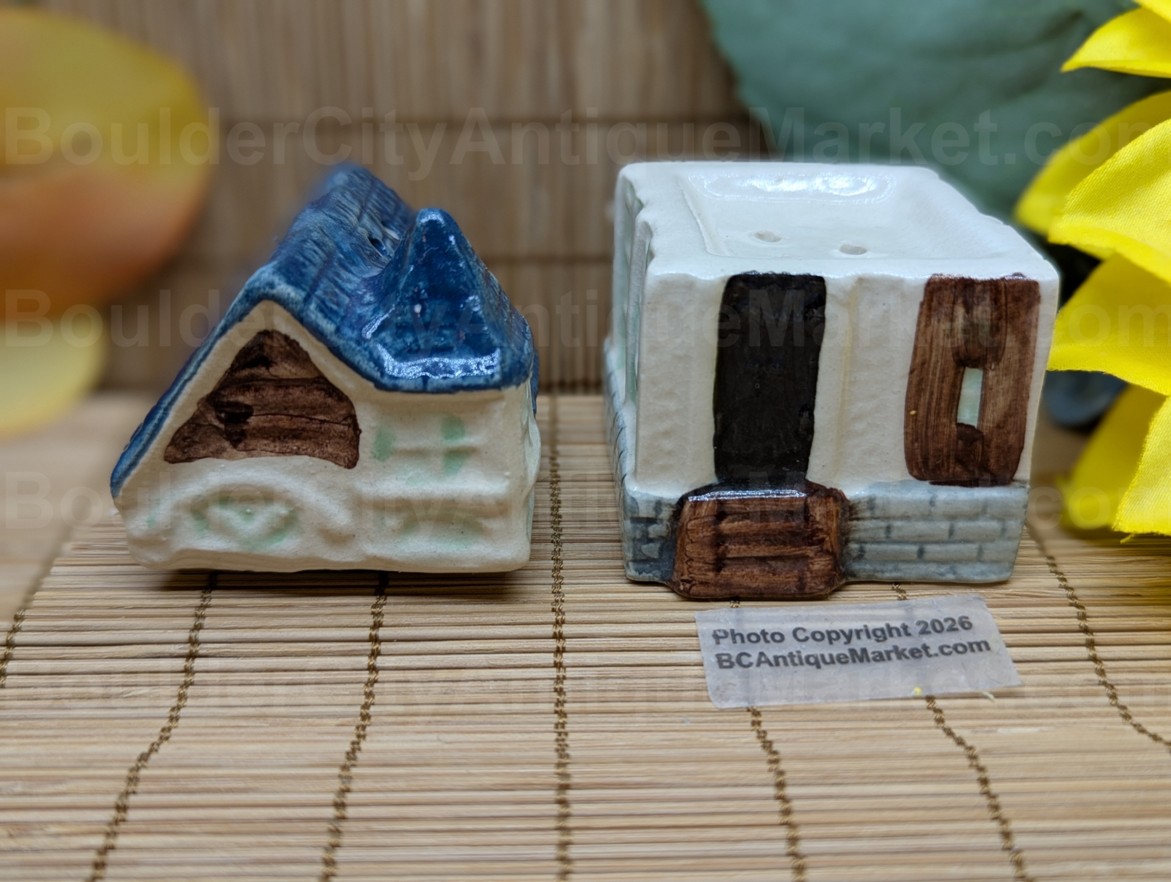 Blue roofed greenish and beige house salt and pepper set stands three inches tall when stacked.