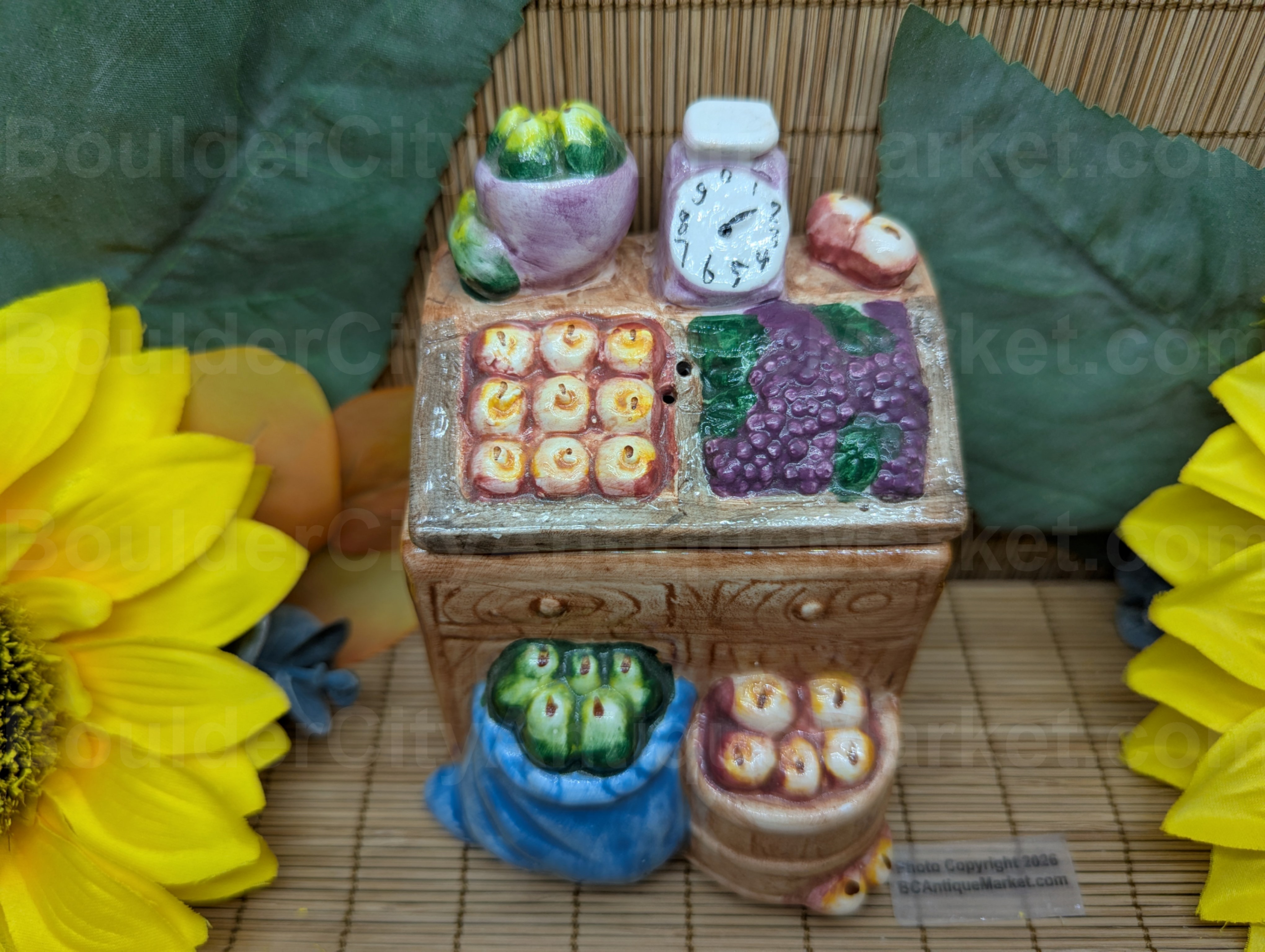 Super cute 4.5-inch-tall market stand salt and pepper set features a scale along with the produce.