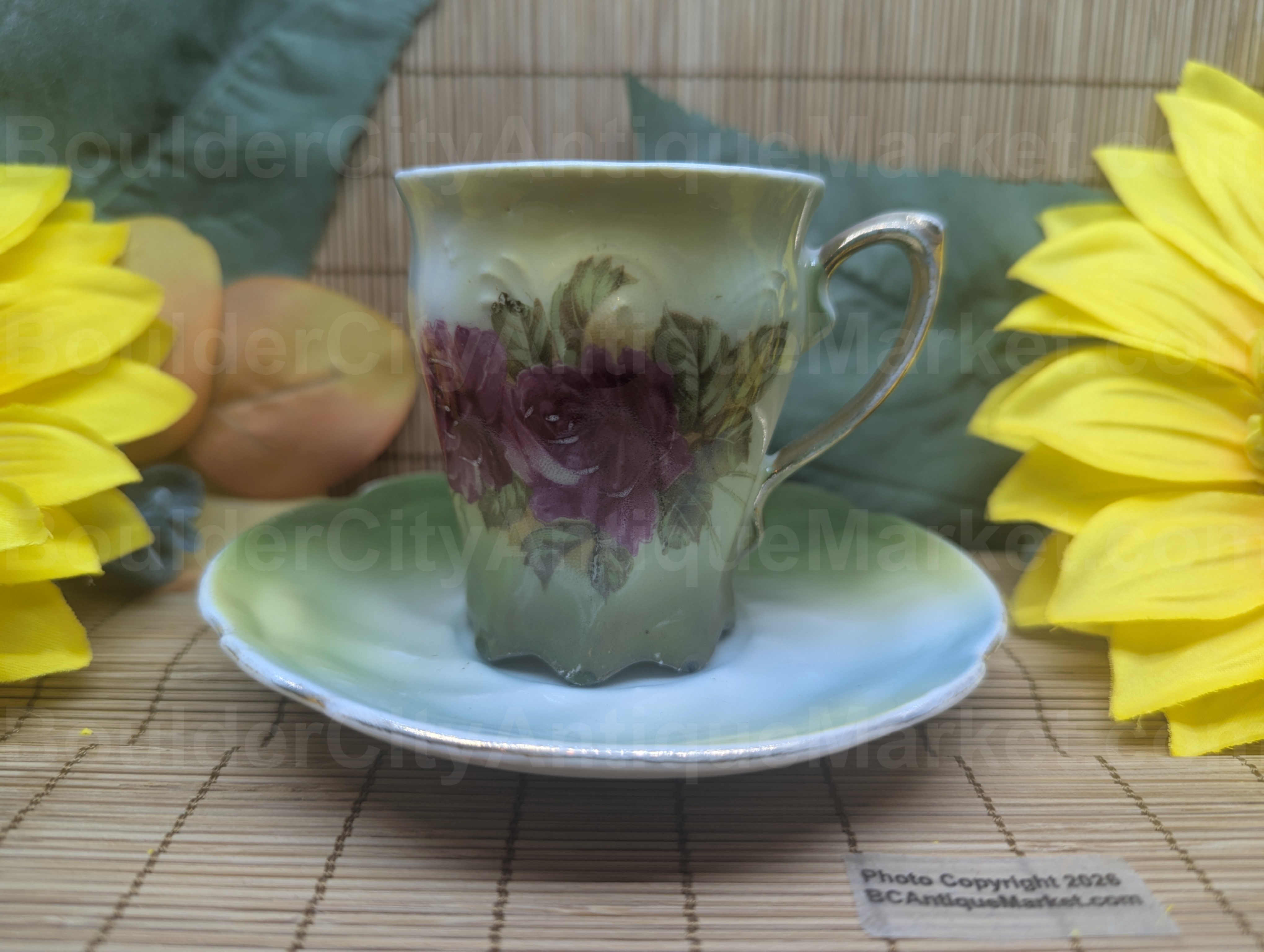 We believe this set predates the 1920s. Hand-painted roses on a green and yellow gradient background with gold details on the cup handle, foot and around the edge of the saucer. The cup is 2.75 inches high and 2.25 inches in diameter. The 4.75-inch diameter saucer has a box scalloped edge. Both pieces show wear on the gold, edges and saucer surface, as to be expected from a piece of this age, so please check the pictures carefully. Cups are marked Imperial Germany, the saucers are not marked.