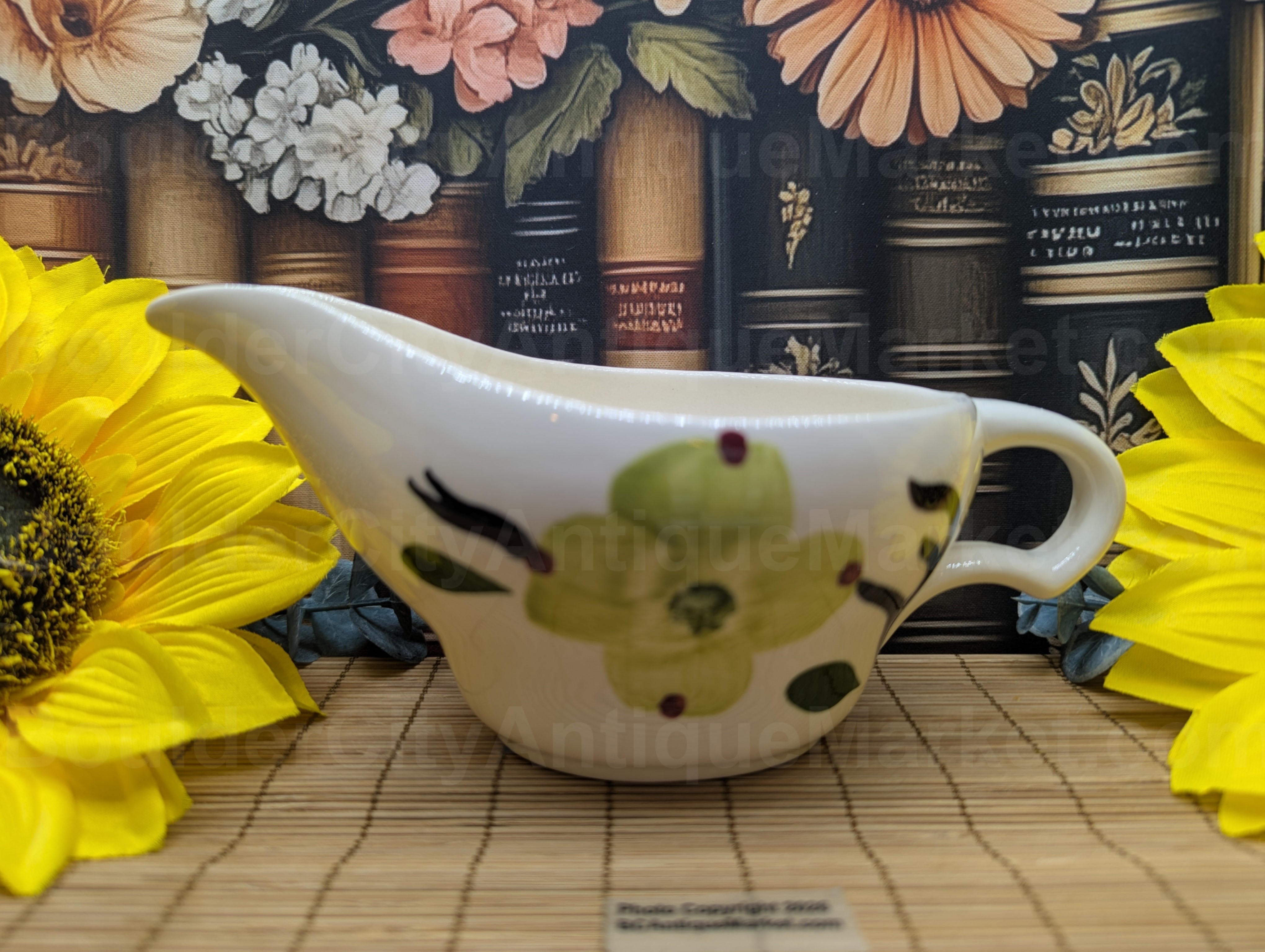 Blue Ridge Pottery was manufactured between 1930-1957 by Southern Potteries Inc. This is the popular Dixie Dogwood pattern featuring a yellow dogwood bloom, green leaves and brown branches. Stands just under three inches tall and seven inches long.