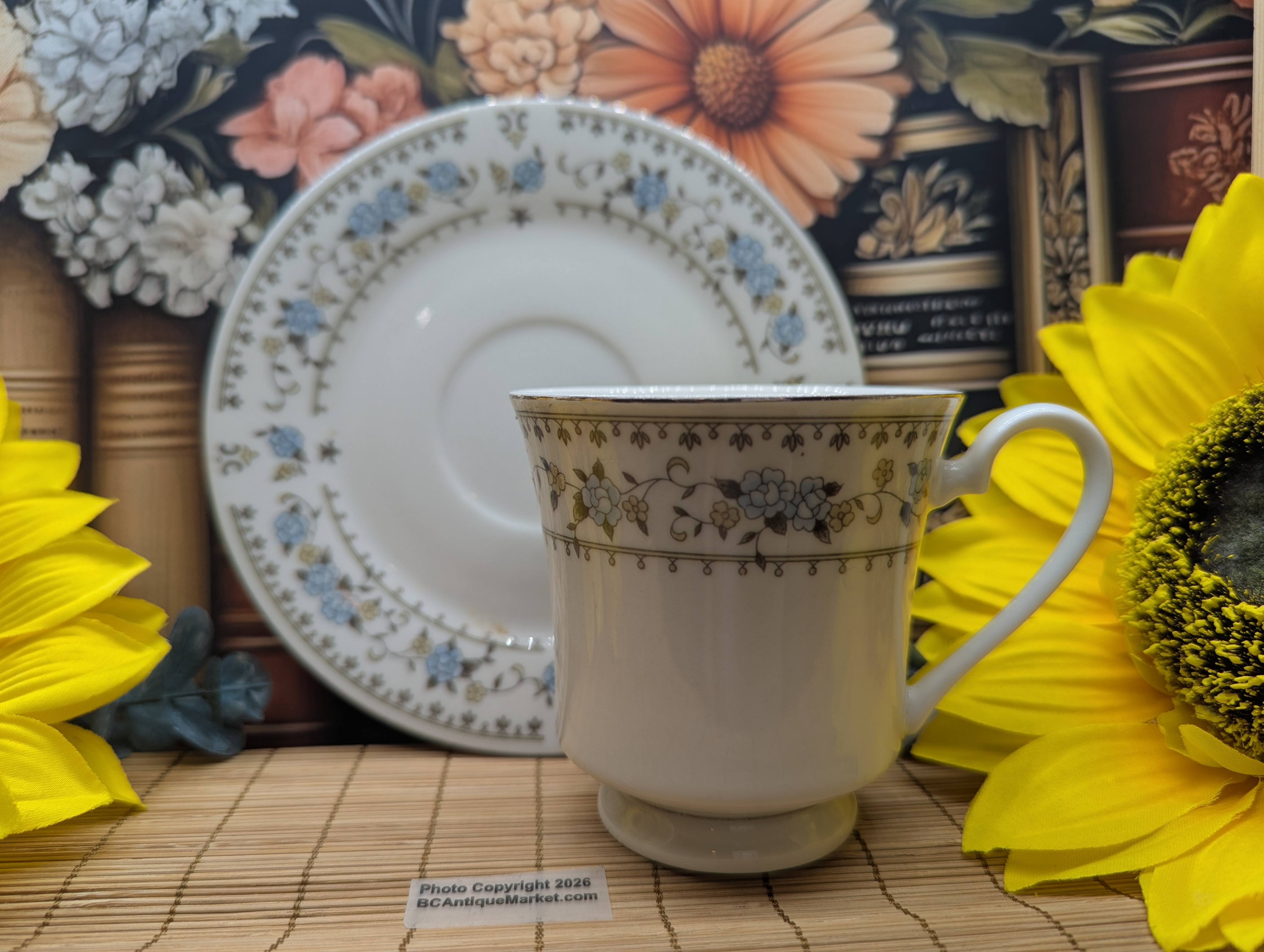 Dynasty Fine China, made in China, pattern listed as Sue or Elegance depending on source. It is from the 1980s and has a delicate blue, gray, silver and peach floral pattern.