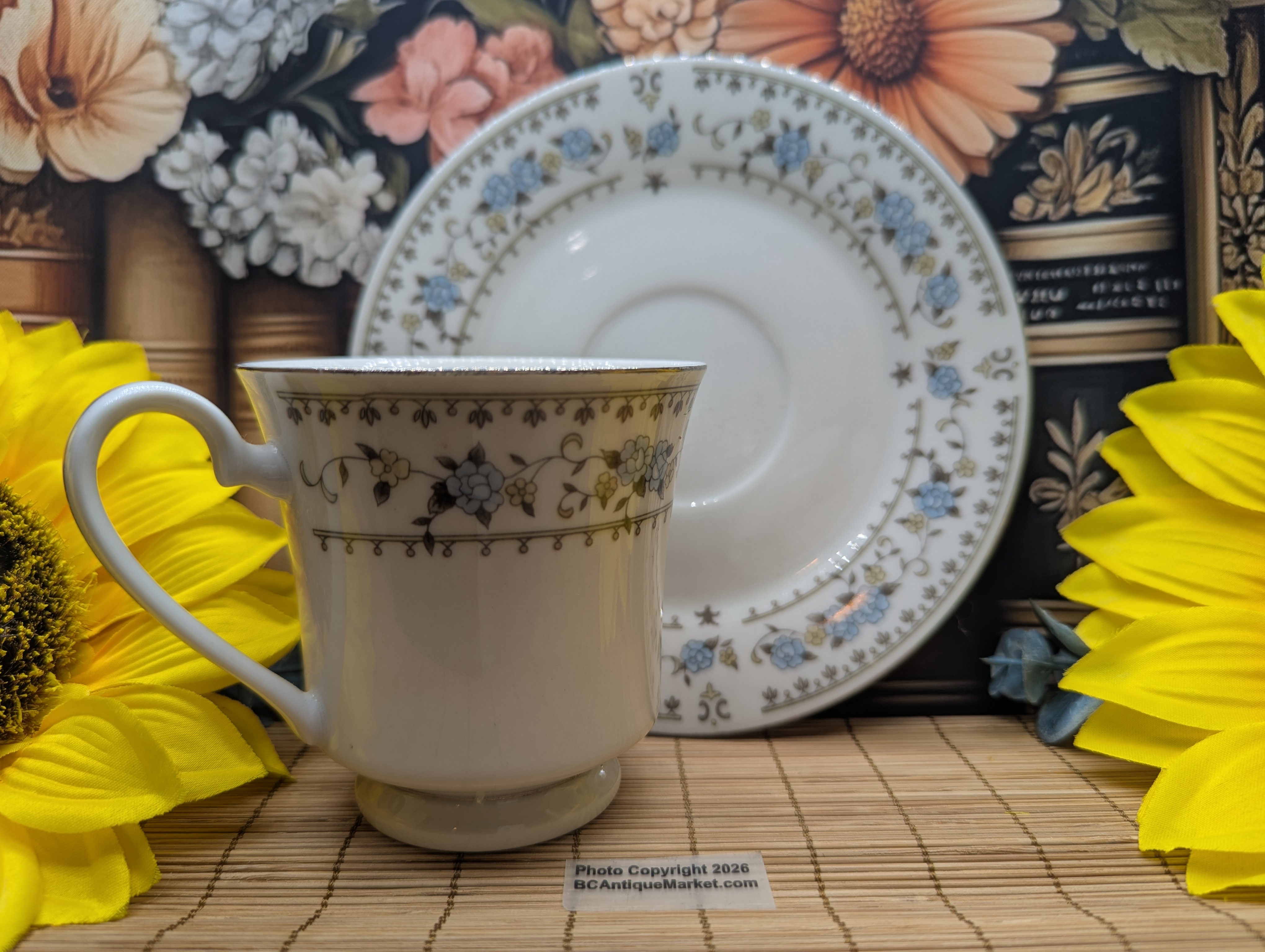 Dynasty Fine China, made in China, pattern listed as Sue or Elegance depending on source. It is from the 1980s and has a delicate blue, gray, silver and peach floral pattern.
