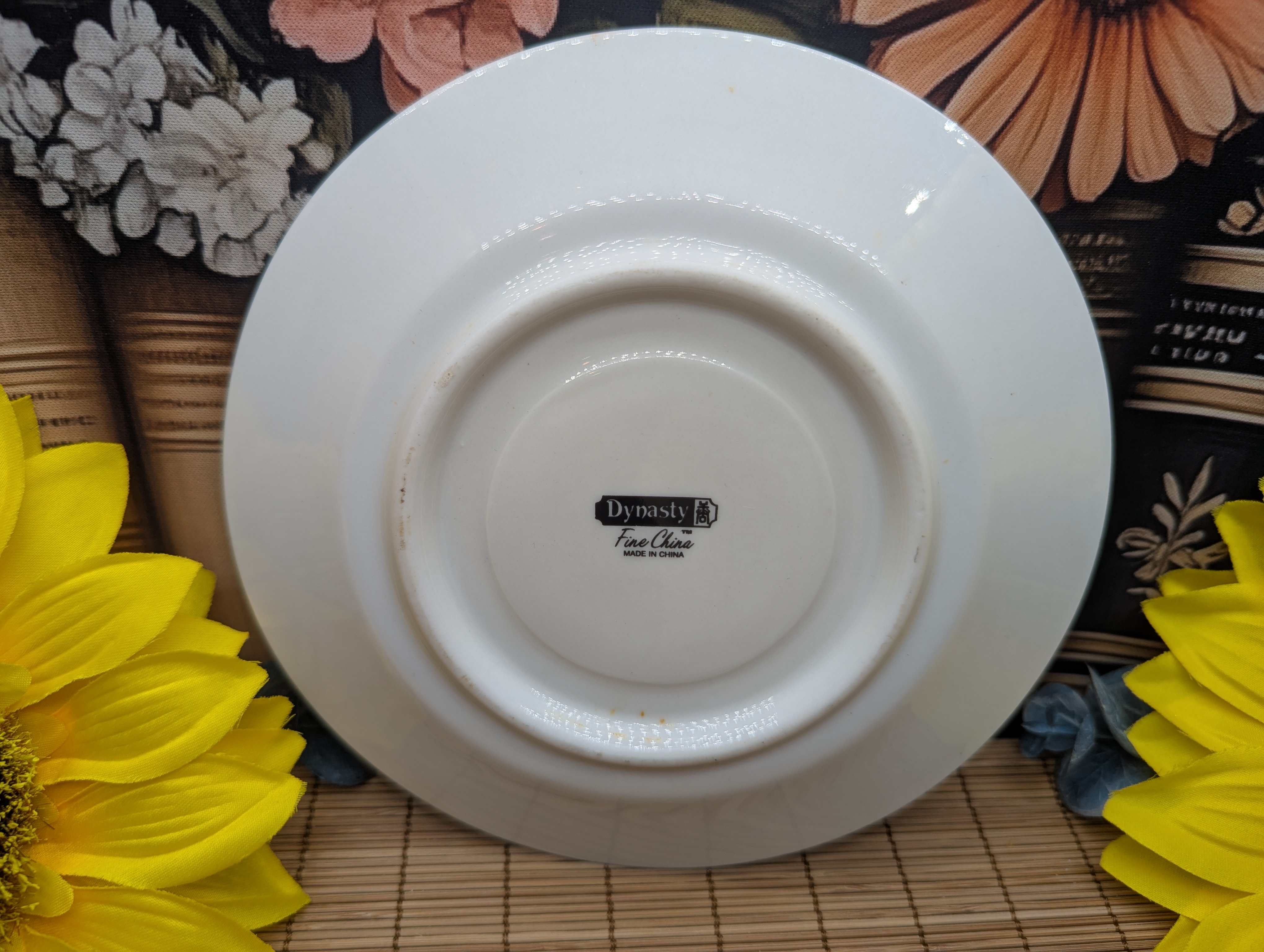Dynasty Fine China, made in China, pattern listed as Sue or Elegance depending on source. It is from the 1980s and has a delicate blue, gray, silver and peach floral pattern.