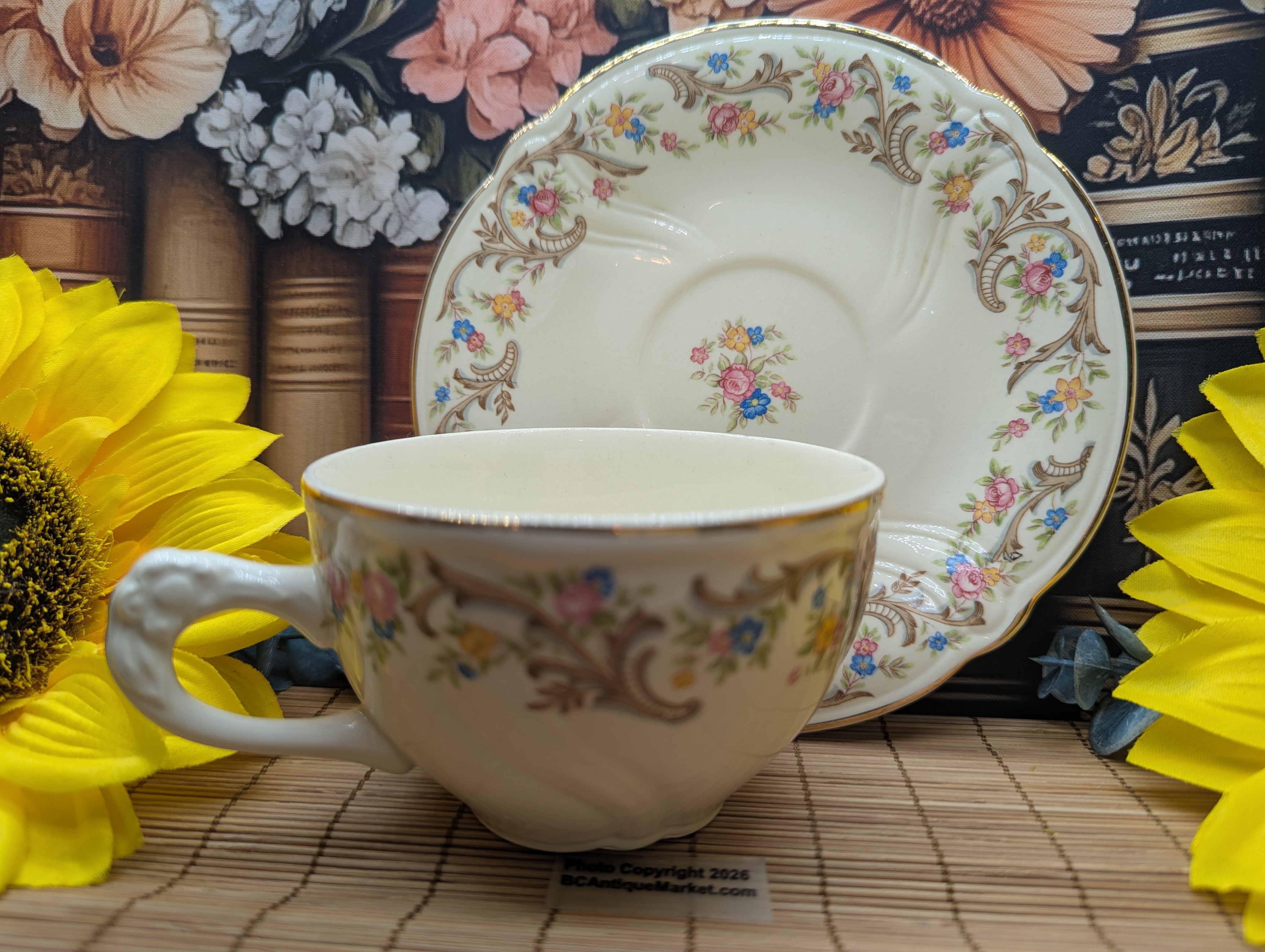 Taylor Smith Taylor teacup and saucer, detailed flower handle. Gold trim on the scalloped six-inch saucer and on the rim and handle of the 3.75-inch diameter teacup. The design number is 1631 and was manufactured around 1945 to 1955.