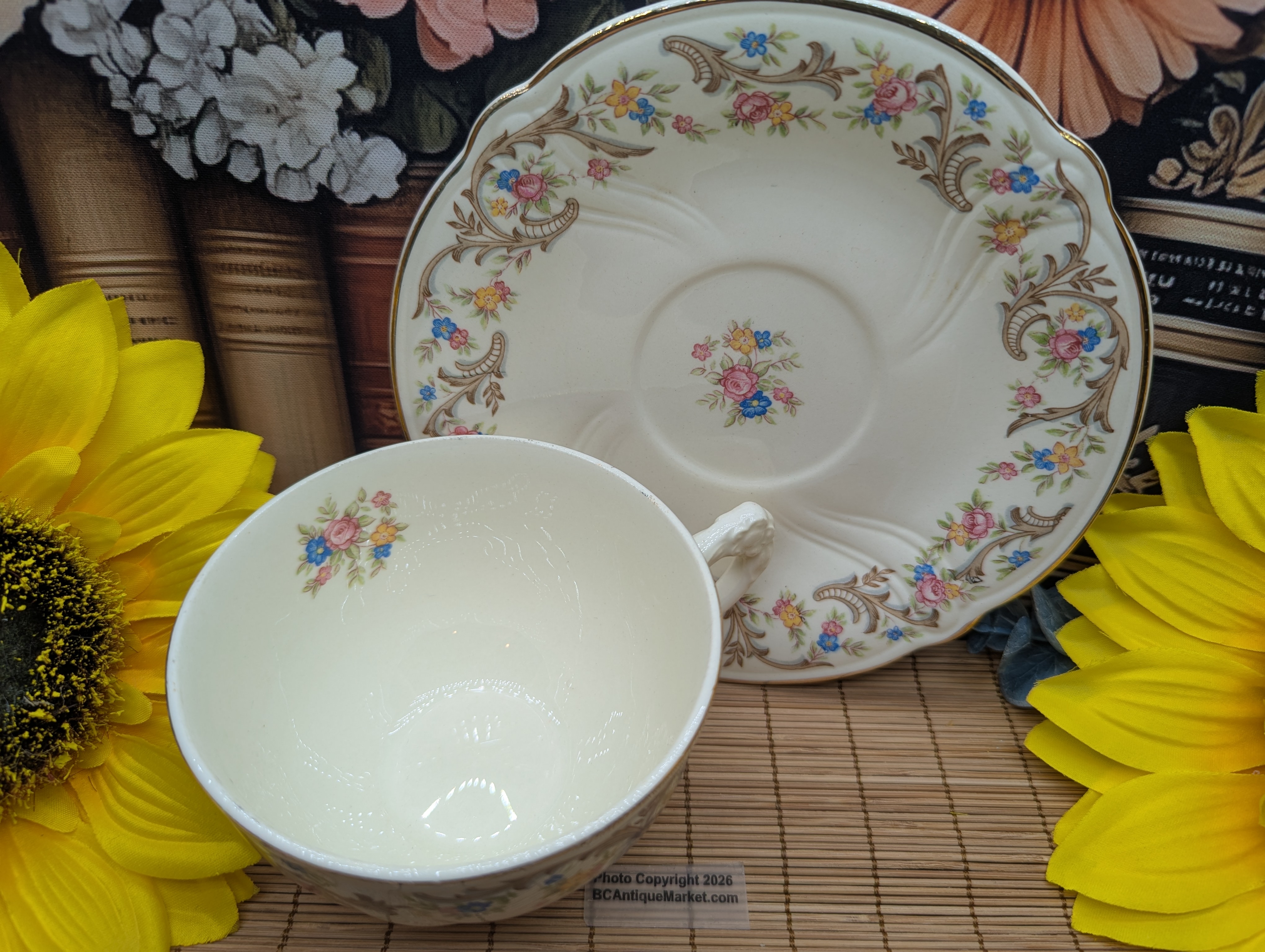 Taylor Smith Taylor teacup and saucer, detailed flower handle. Gold trim on the scalloped six-inch saucer and on the rim and handle of the 3.75-inch diameter teacup. The design number is 1631 and was manufactured around 1945 to 1955.