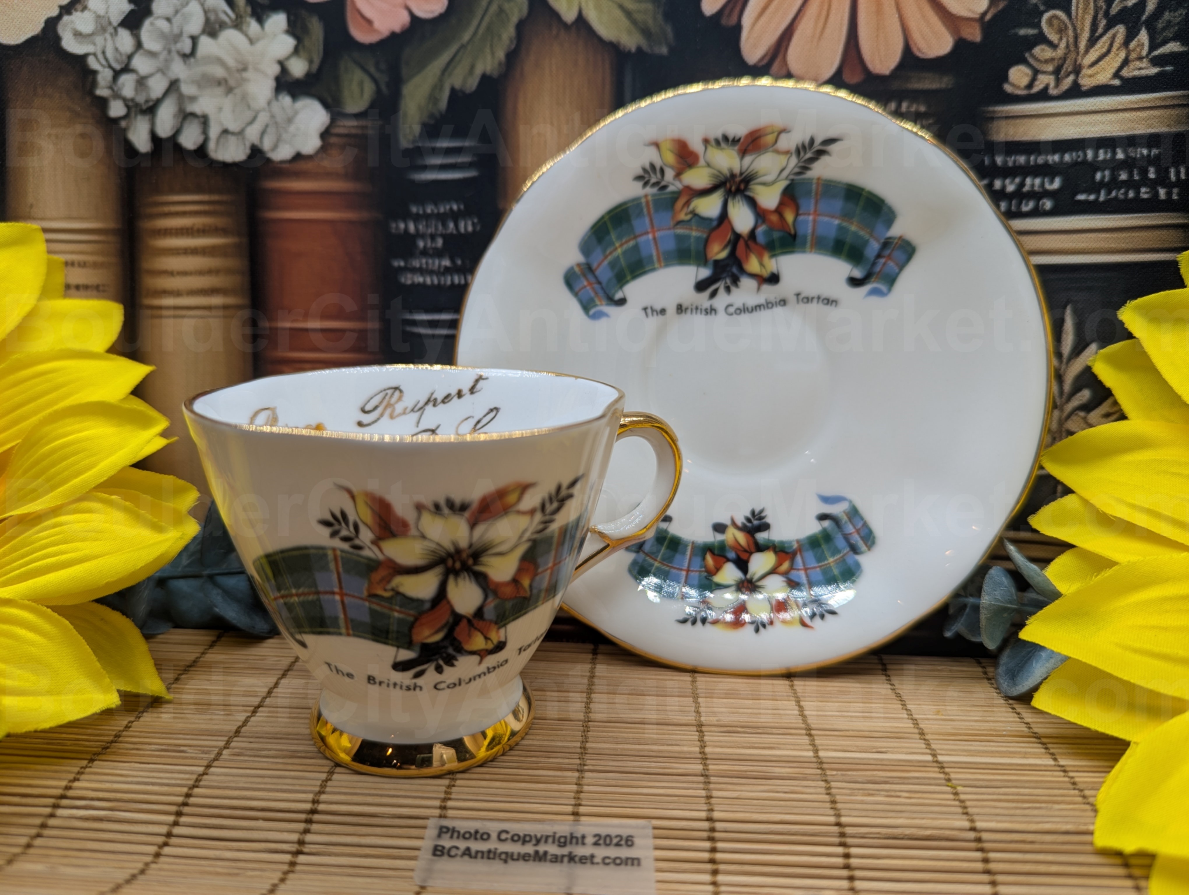 Demitasse cup showcasing the British Columbia Tartan pattern. Marked inside with Prince Rupert B.C. Gold edged on the 4.5-inch diameter scalloped saucer, the 2.75-inch scalloped diameter cup has gold on the rim, handle, inside and foot. Slight wear on the U in Columbia on the teacup, please check pictures.