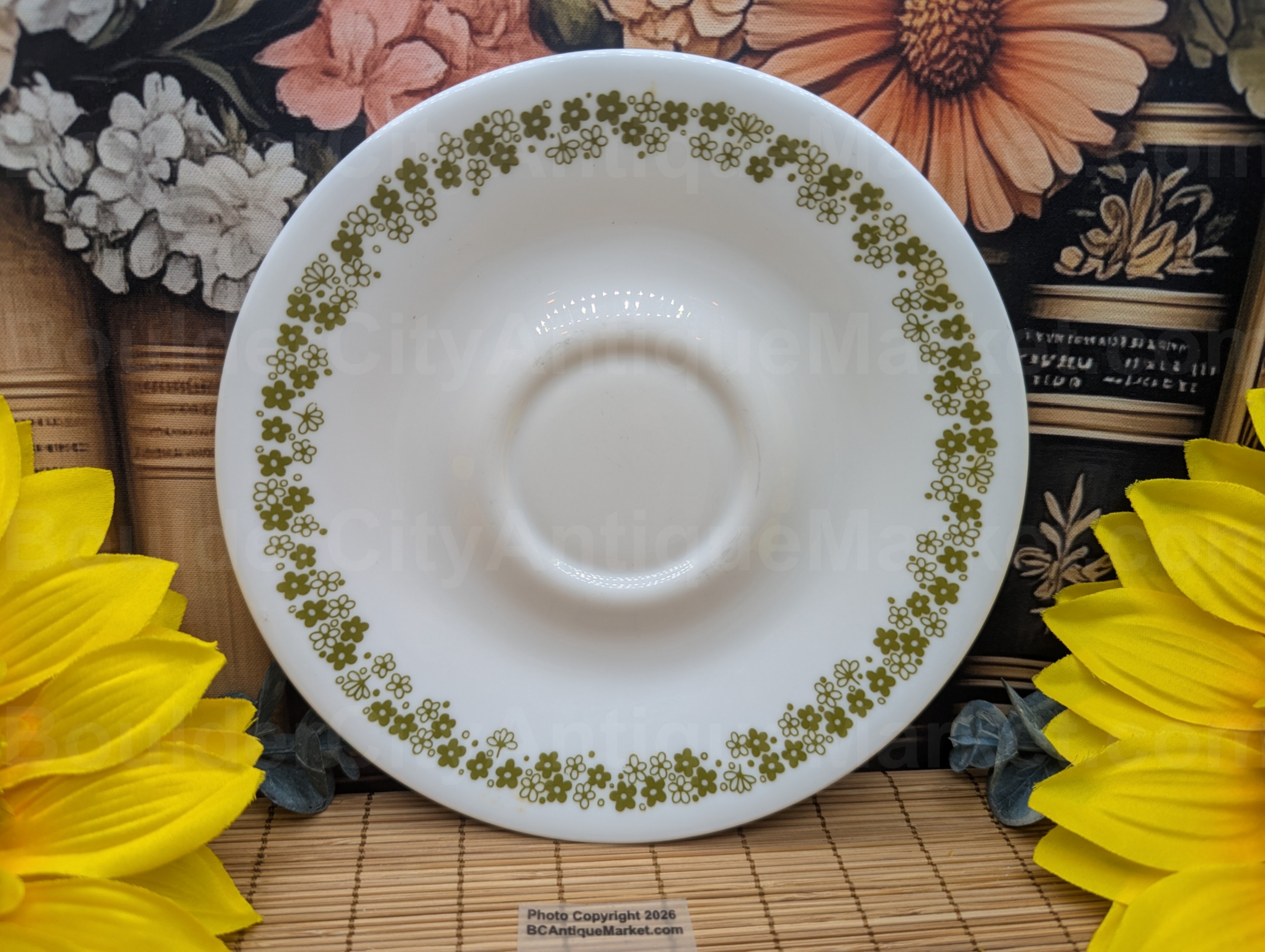 6.25-inch saucer in the Corelle Spring Blossom Green (Crazy Daisy). Manufactured between 1972 to 1986 with a redesign in 1979 as one of the original Corelle Livingware patterns.