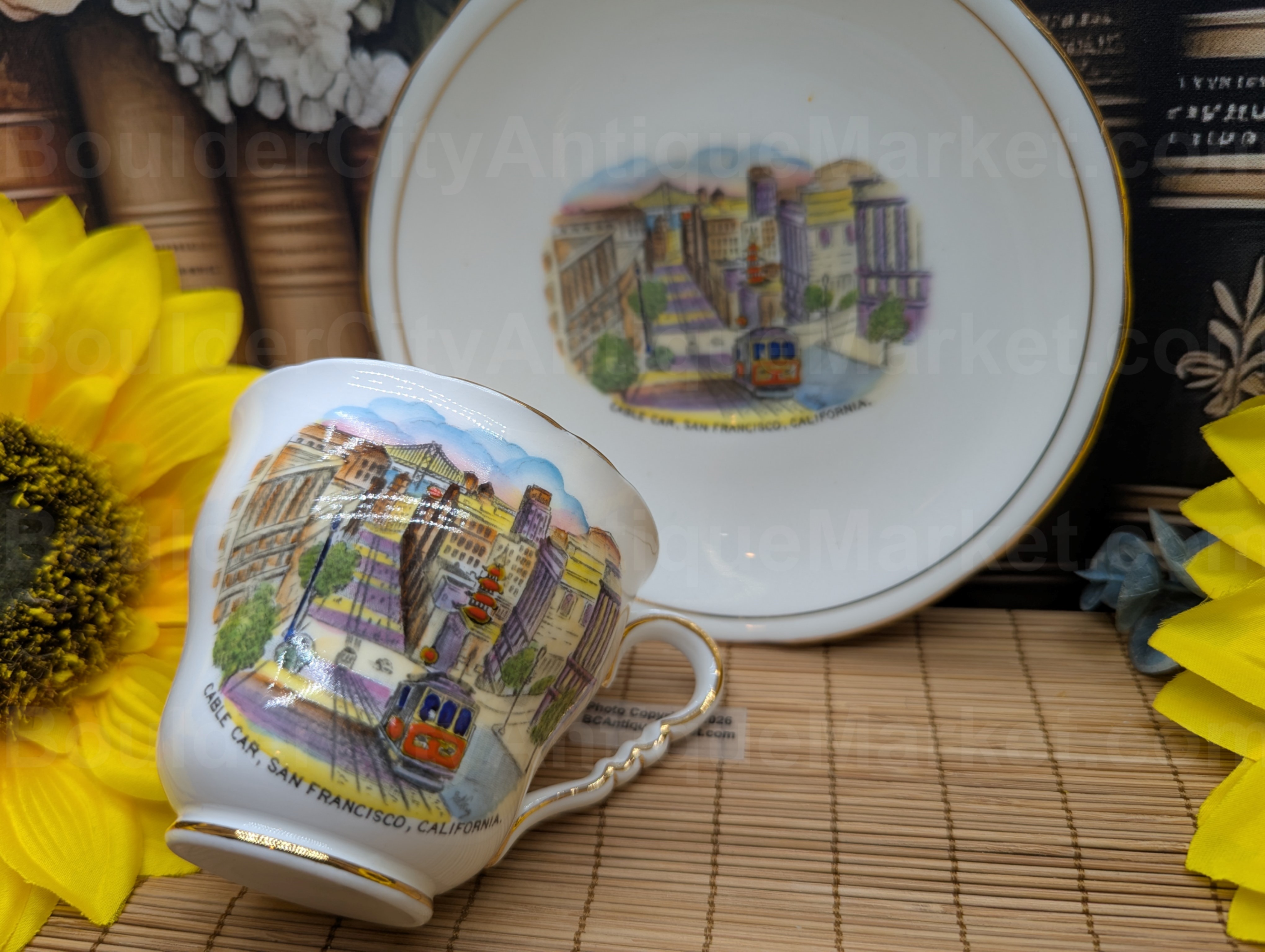 Royal Stafford Fine Bone China, Made In England, in a Cable Car design from San Francisco, California. The saucer is 5.5-inches in diameter, and the teacup is 3 1/8-inch in diameter. Both the teacup and saucer have gold detail rings on edges, foot of cup and cup handle. The San Francisco design has raised details and is very vibrant.