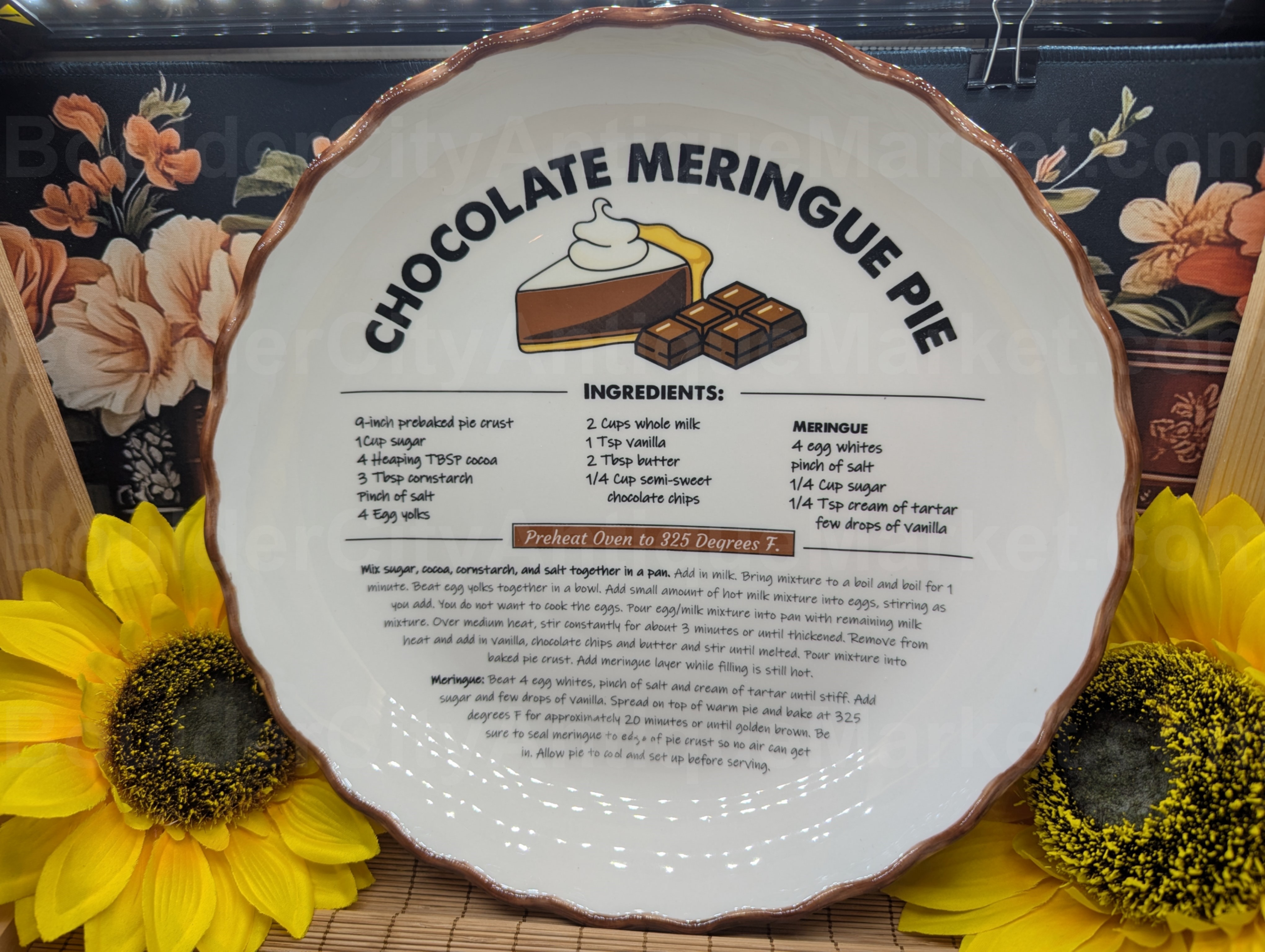 Eleven-inch diameter and two-inch-deep off-white ceramic pie plate with a brown edge and a full Chocolate Meringue Pie recipe in the inside. No manufacturer's mark.