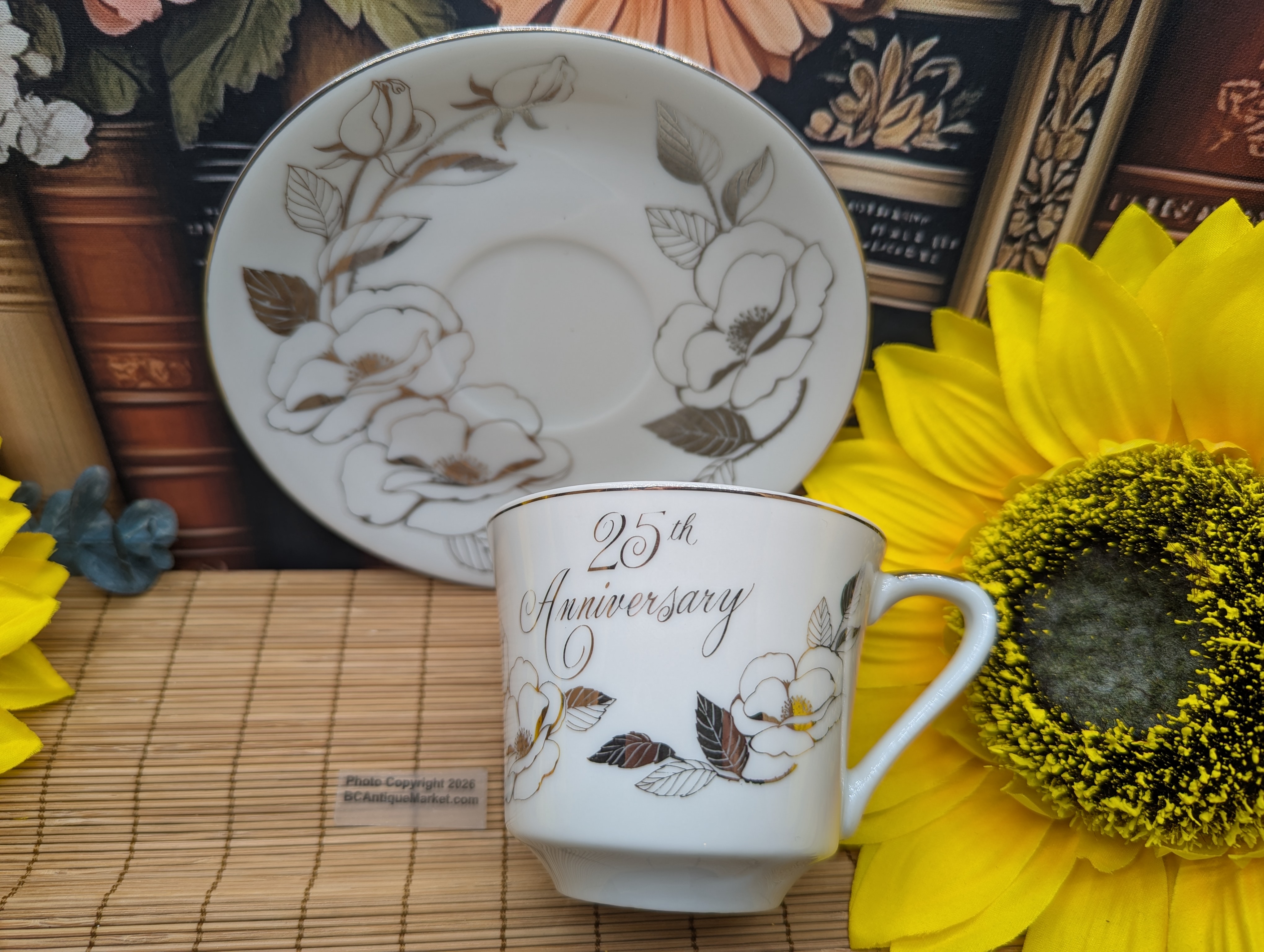 Extensive details in silver on this 25th Anniversary teacup and saucer. Porcelain and sporting a Japan sticker on the 5 1/2-inch saucer, there are no further manufacturer's markings on the 3 3/8-inch teacup.